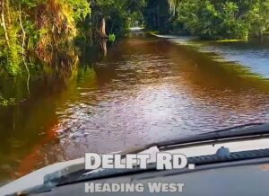 Photo of a flooded street labeled "Deleft Rd. heading west".