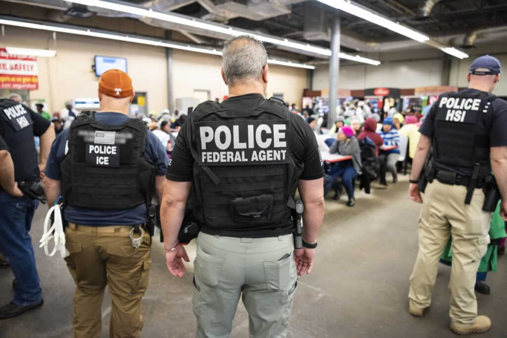 ICE agents raid a workplace.