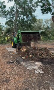 A vehicle dumping compost or soon-to-be compost on the ground.