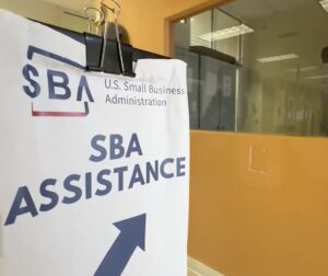 Photo of a sign for "SBA Assistance" with an arrow pointing up and to the right.