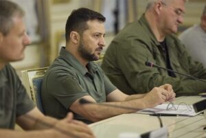 President Zelenskiy in profile with a serious expression.