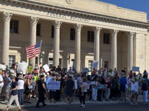 Protesters gather outside the federal building at 111 South Orange Avenue.