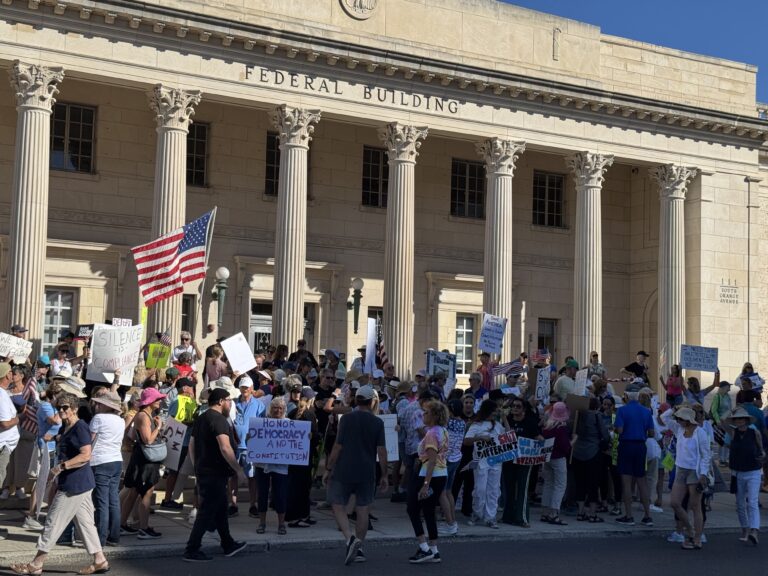 Protesters gather outside the federal building at 111 South Orange Avenue.