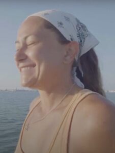 Bailey Mull smiling while sailing.