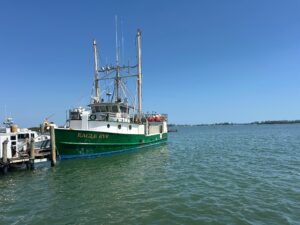 A docked fishing boat. The name "Eagle Eye" is painted on the side.