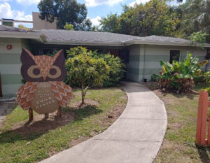 New College Child Center. The sign out front is a sculpture of an owl with the building's name on its belly.