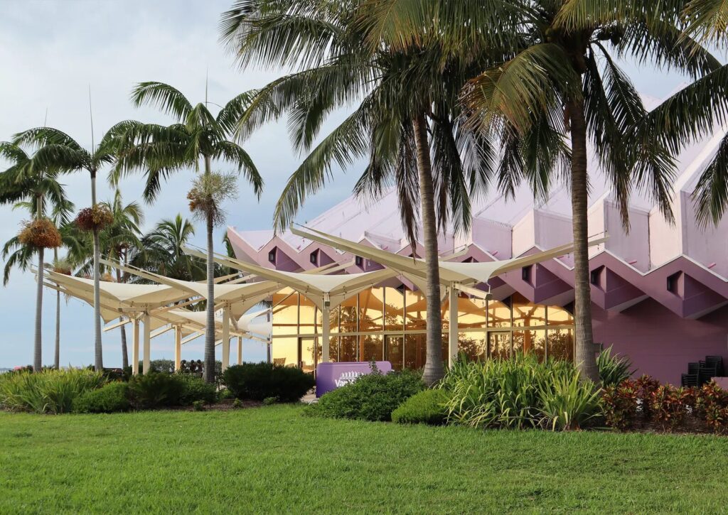 The Van Wezel, a modern purple building with palm trees lining the outside.