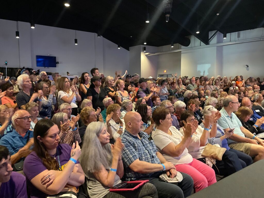 A large crowd packs a church auditorium.