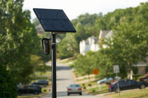 Photo of a camera on a pole powered by a solar panel.
