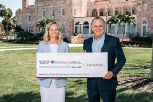 Richard Corcoran and Sydney Gruters holding a giant check made out to the New College Foundation in the amount of $2.5 million.