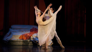 Two costumed ballet dancers posing onstage.
