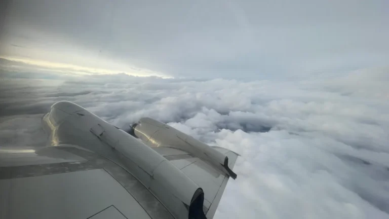 Photo of the wing of a WP-3D Orion plane above the clouds.