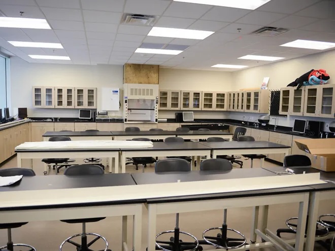 A tidy classroom, empty of students.