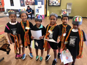Photo of six young children wearing t-shirts for the African American Cultural Research Center in Sarasota and smiling.