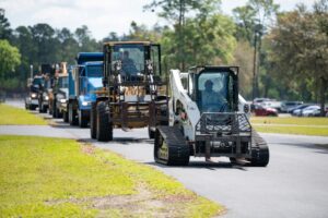 Construction equipment being driven down a road.