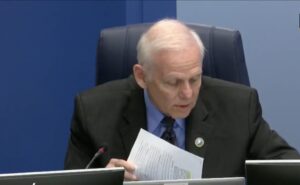 Bob McCann reviewing notes while speaking.