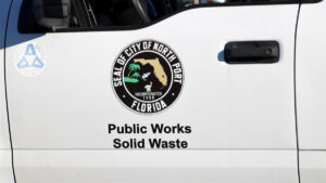 Car door with the North Port city seal and the text "Public Works Solid Waste".