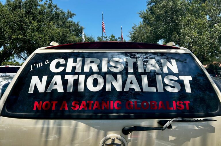 Decal on the back window of a vehicle that reads "I'm a Christian nationalist not a Satanic globalist".