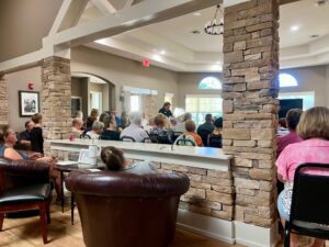 Photo of a crowd gathering for a meeting in Harrison Ranch's modern clubhouse.