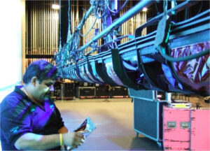 Contemporary photo of a stagehand working on the set of a stage production.