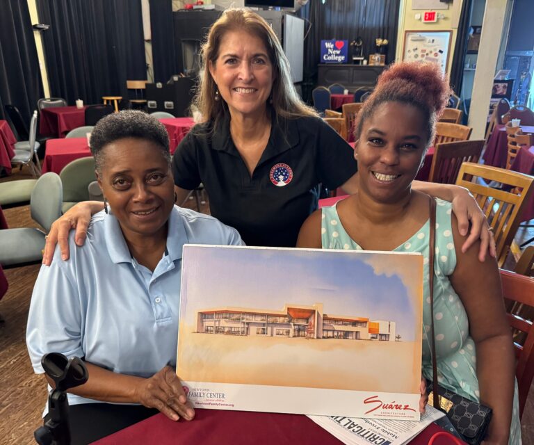 Helen Neal-Ali, Geri Chaffee, and Shinece Davis presenting a printed rendering of the Newtown Family Center building and smiling.