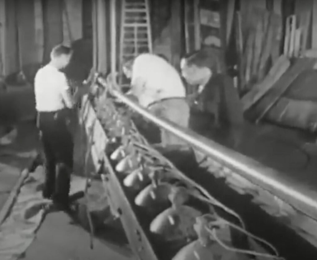 Black and white movie still of stagehands working on the lighting for a stage production.