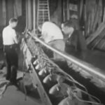 Black and white movie still of stagehands working on the lighting for a stage production.