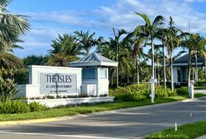 A sign outside a community that reads "The Isles at Lakewood Ranch by Toll Brothers".
