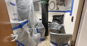 Furniture items protected with gaffers tape and plastic wrap.