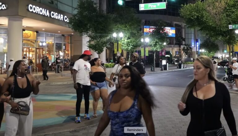 Photo of people out and about outside an Orlando mall at night.