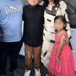 Eddy Macario, Benita Cantero, and their two children with faces blurred for privacy.