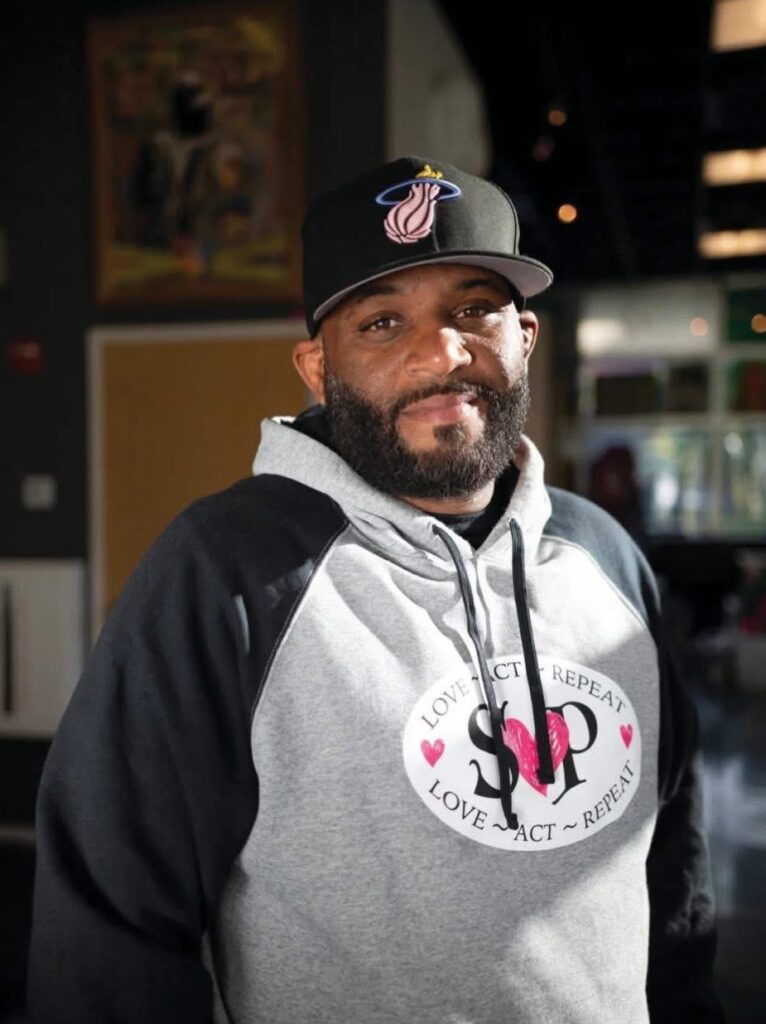 Greg Cruz wearing a Streets of Paradise sweatshirt.