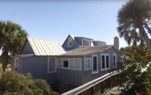 Photo of a building with a wooden bridge leading to it.