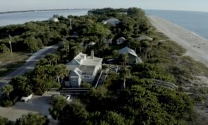 Aerial photo of a cluster of buildings along the coast.