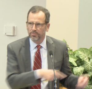 Charles Bailey III gesticulating while speaking.