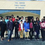 A group gathered outside the entrance to the Full Service Family Center at Harllee.