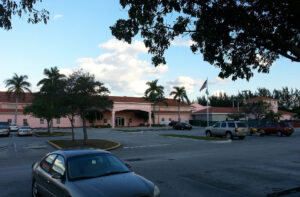 Photo from the parking lot of a facility with a sign that reads "Broward Transitional Center".