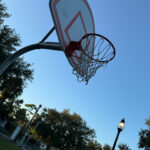 Photo of a basketball hoop in a park.