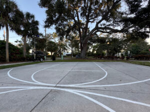 Photo of an outdoor basketball court sans hoops.