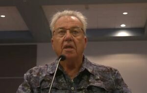 Joe McClash speaking into a microphone.