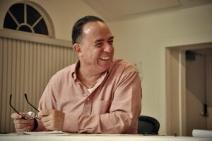 Juan Pablo Salas laughs while looking off-frame.