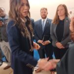 Kristi Noem shakes someone's hand.