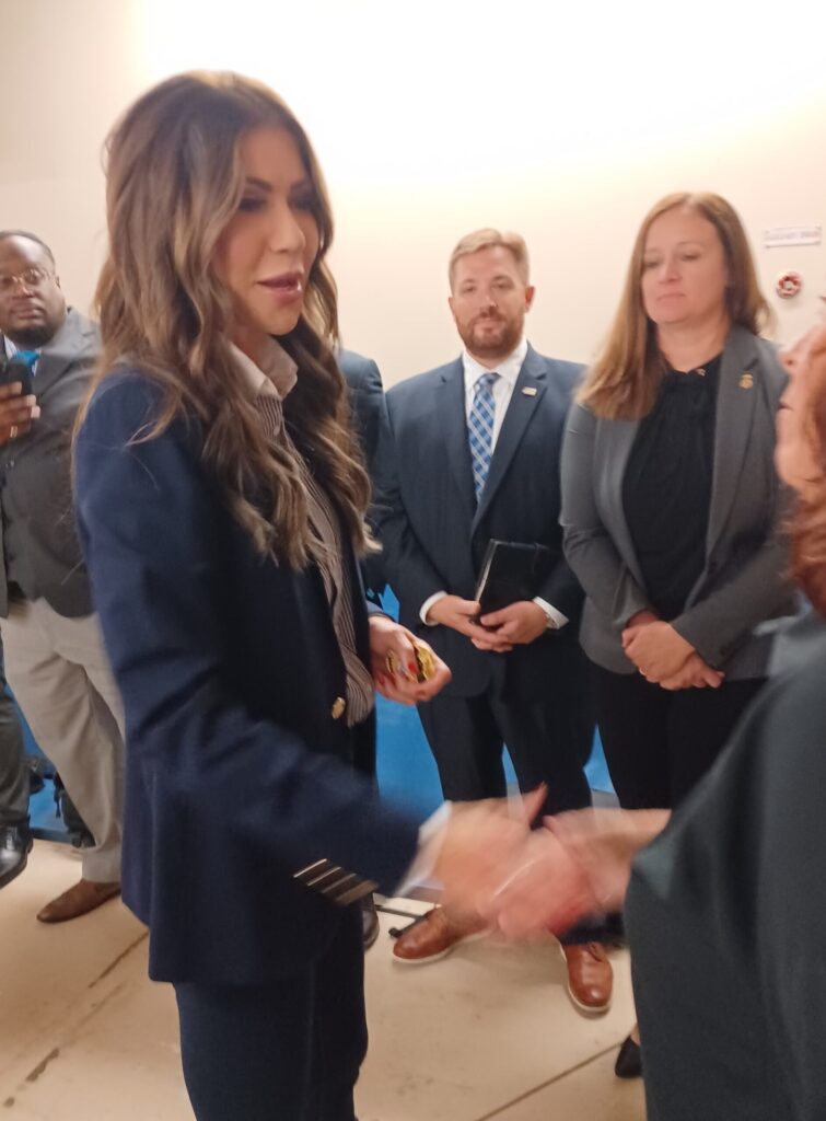 Kristi Noem shakes someone's hand.