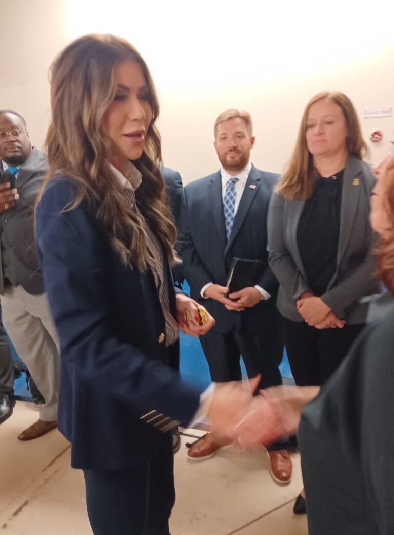 Kristi Noem shakes someone's hand.