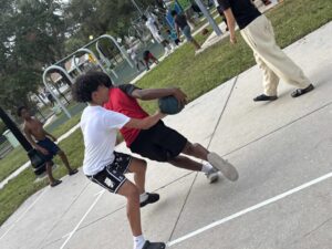 Children play basketball in a park.