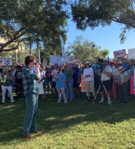 Zander Moricz addresses an anti-Trump crowd outdoors.