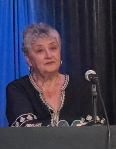 Bohdana Puzyk speaking into a microphone.