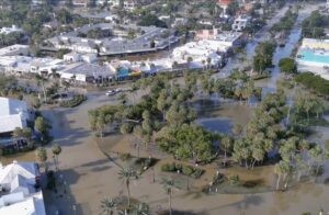 Aerial photo showing a roundabout flooded with murky water.
