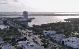Aerial photo of a flooded waterfront road.
