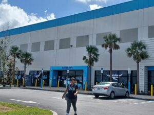 A person outside the entrance to an Amazon distribution center.